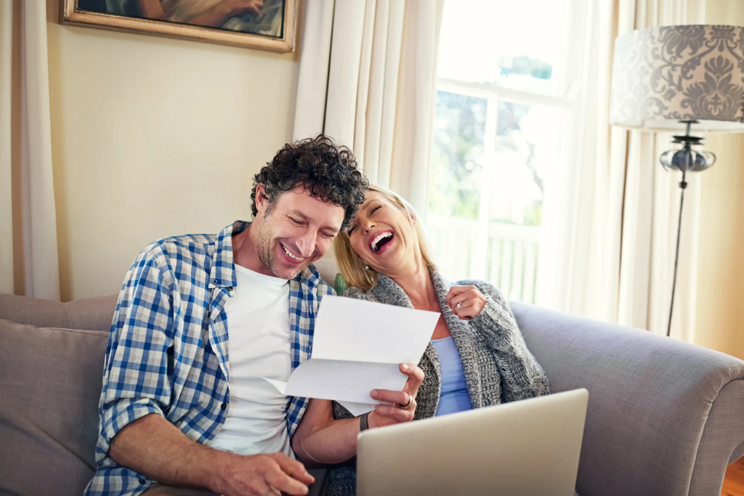 A happy couple reviewing paperwork.