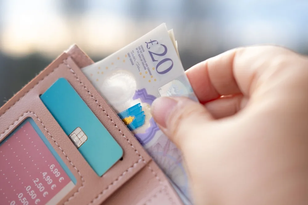 Someone taking money out of a wallet.