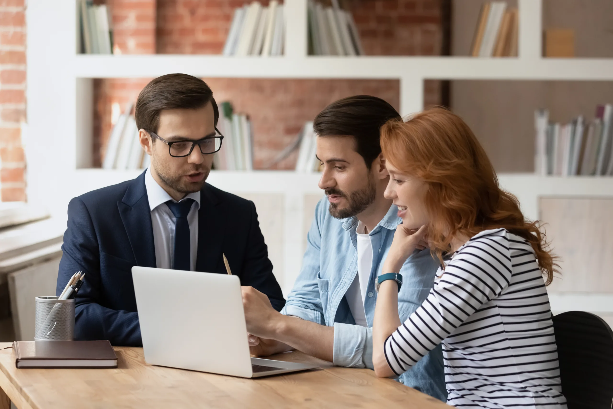 A couple speaking to a financial planner.